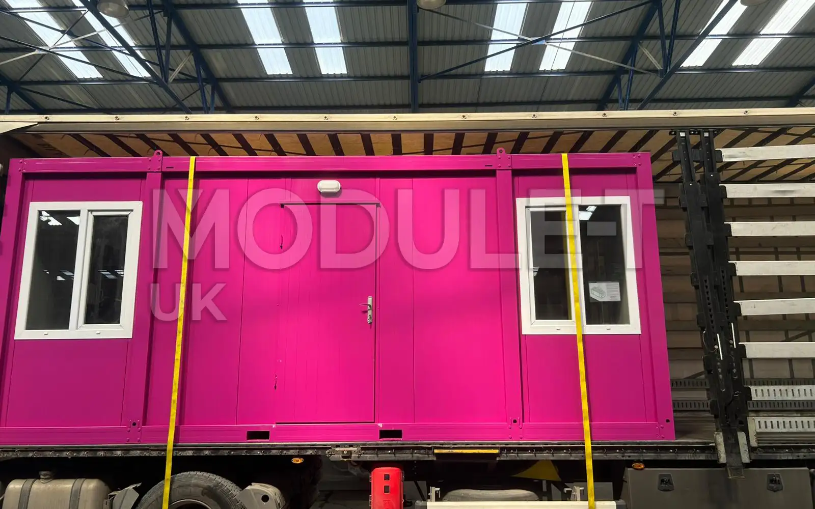 Pink office container loading for transport — Module-T UK